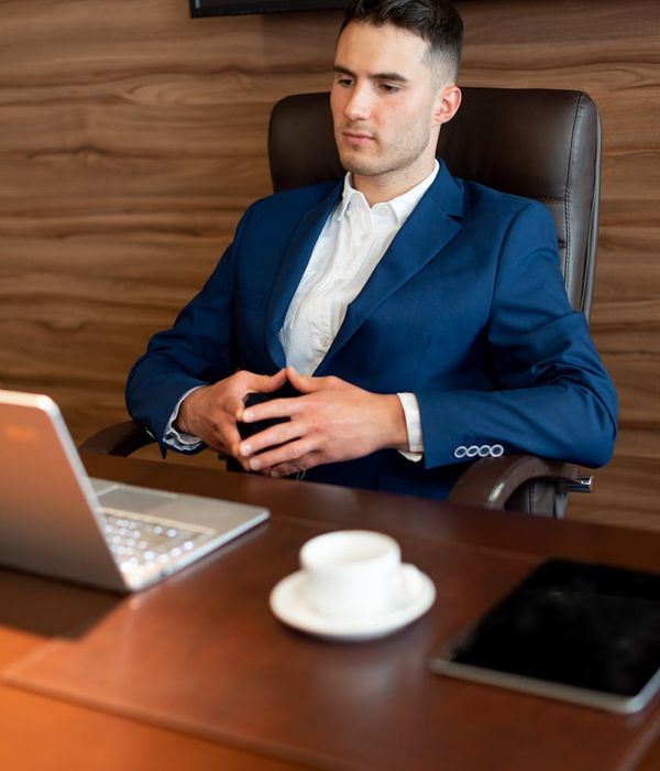 Person working at a desk in a modern office looking relaxed.