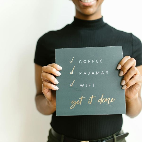 Woman smiling and doing a simple cardio exercise at home.